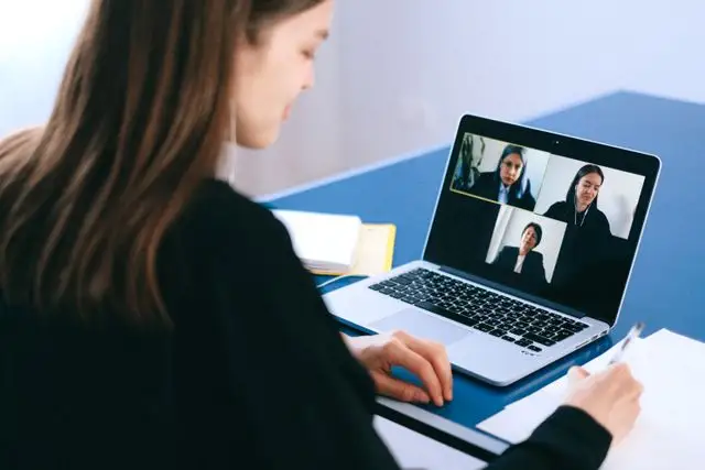 Business professional collaborating with a nearshore staffing team on a video call